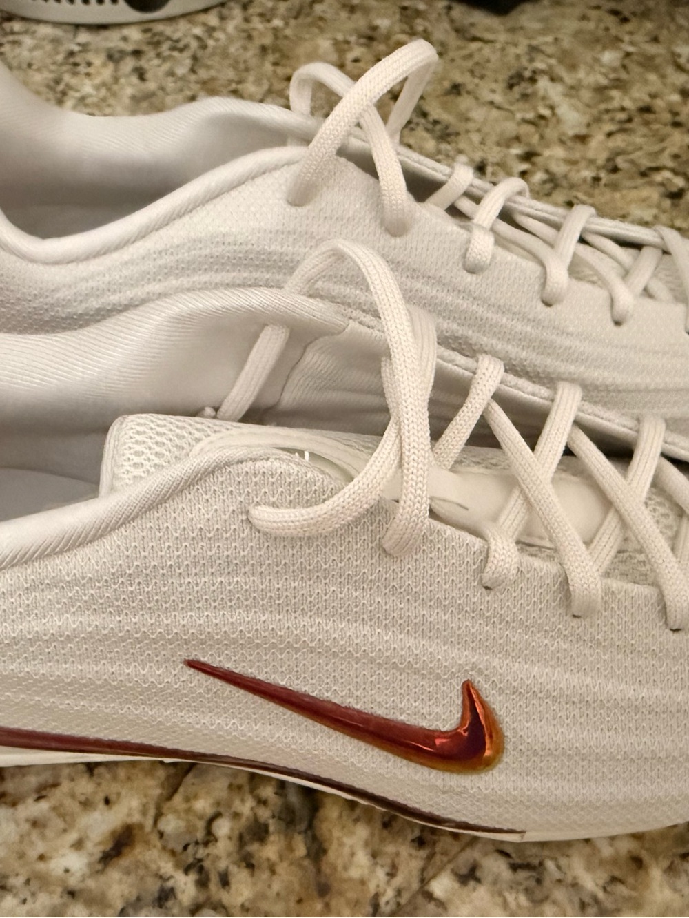 Nike White Knit Sneakers with Metallic Red and Gold Swoosh Accent